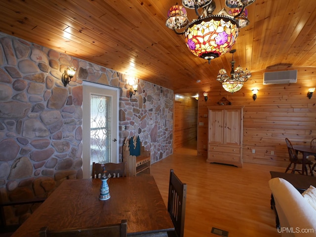 dining space with wood ceiling, wood finished floors, a wall mounted AC, and a notable chandelier
