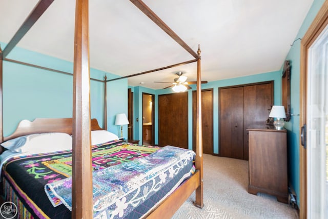 bedroom featuring two closets and carpet flooring