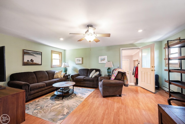 living room with recessed lighting, light wood-type flooring, a baseboard heating unit, and ceiling fan