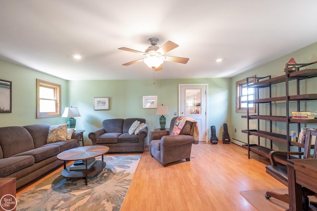 living area featuring light wood finished floors, a ceiling fan, and recessed lighting