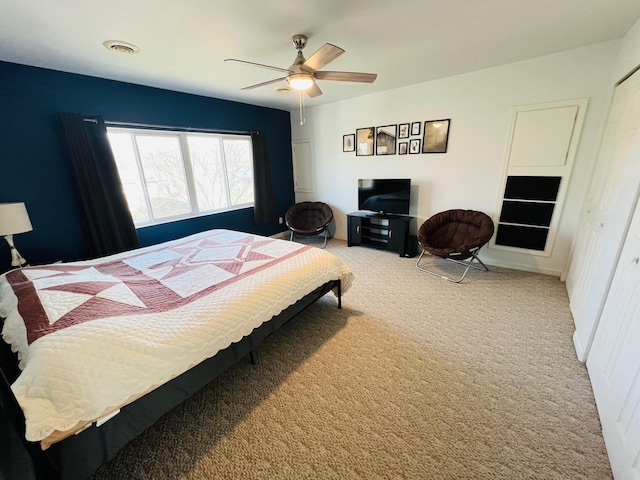 bedroom with carpet, visible vents, and a ceiling fan