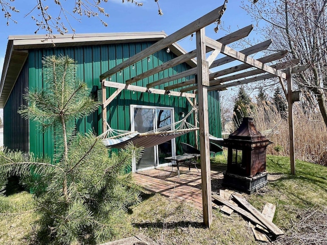 view of outbuilding featuring a pergola