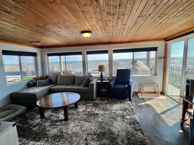living room with a water view, dark wood finished floors, baseboards, wood ceiling, and ornamental molding