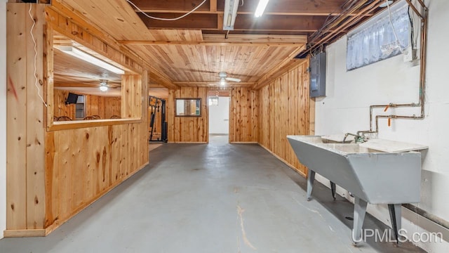 below grade area featuring wood walls and electric panel