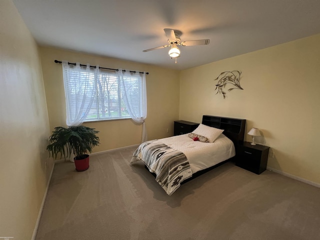 bedroom with ceiling fan, baseboards, and carpet floors