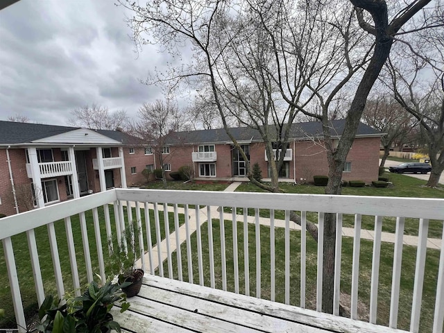 wooden deck with a lawn and a residential view