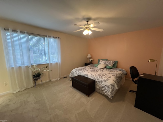 bedroom featuring a ceiling fan, baseboards, and light colored carpet