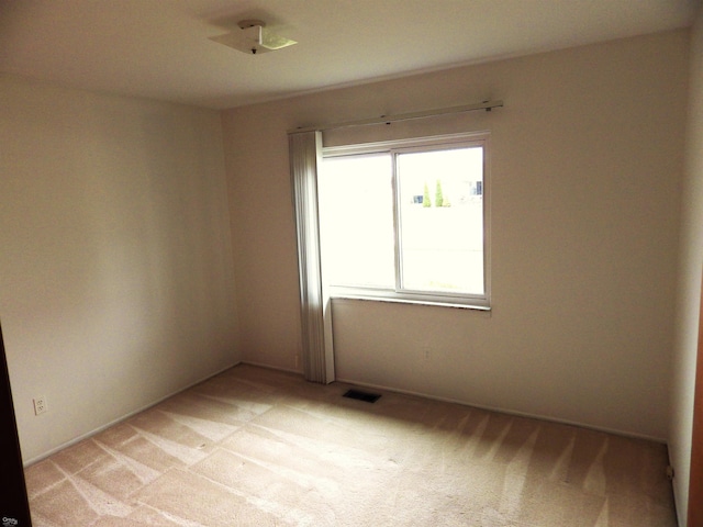 empty room featuring light colored carpet and visible vents