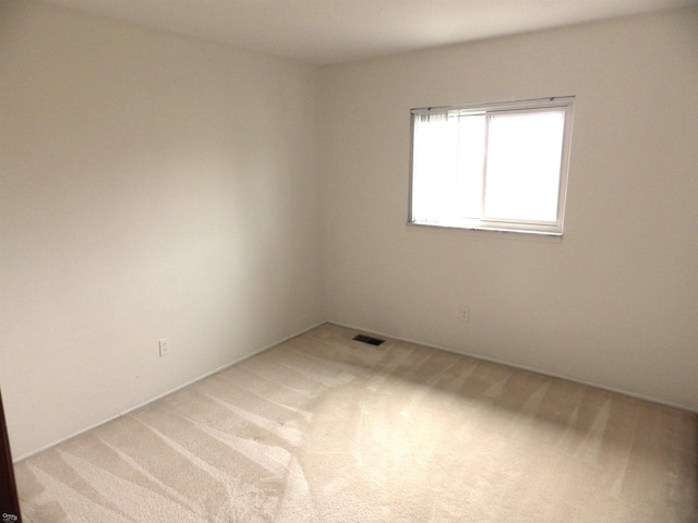 carpeted spare room with visible vents