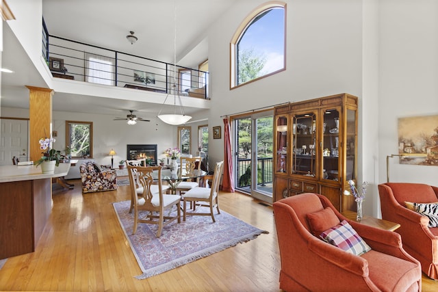 6728 Frith Rd, Smiths Creek, MI 48079 - living area with a towering ceiling, ceiling fan, a wealth of natural light, and a warm lit fireplace