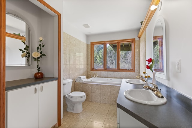 6728 Frith Rd, Smiths Creek, MI 48079 - bathroom featuring a garden tub, toilet, a sink, and tile patterned floors