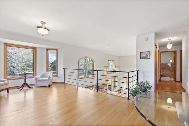 6728 Frith Rd, Smiths Creek, MI 48079 - hall with baseboards, wood finished floors, and an upstairs landing