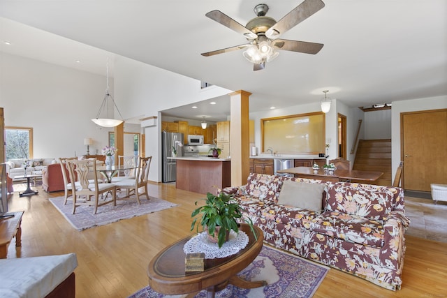 6728 Frith Rd, Smiths Creek, MI 48079 - living area with stairway, ceiling fan, and light wood-type flooring