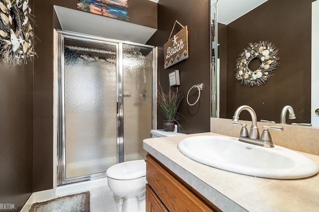 bathroom with vanity, toilet, a stall shower, and tile patterned floors