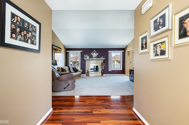 hallway featuring wood finished floors and baseboards