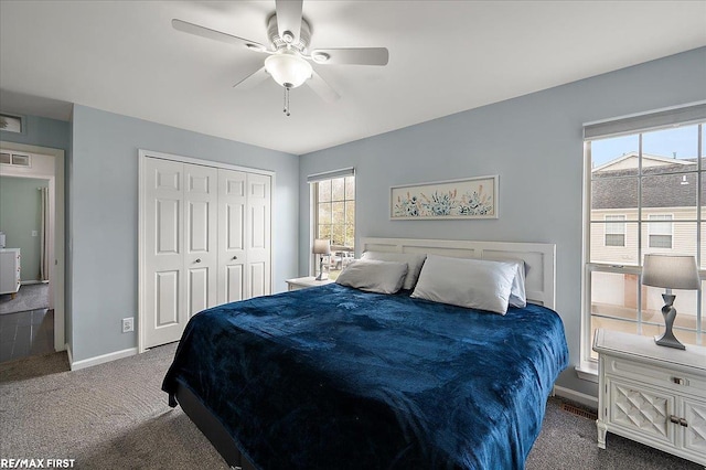 bedroom featuring visible vents, carpet floors, a closet, and multiple windows