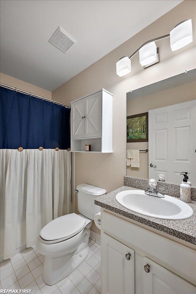 bathroom with visible vents, tile patterned flooring, vanity, and toilet