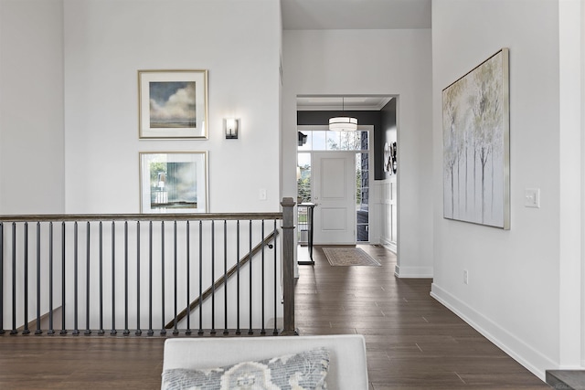 3897 Chatham Pl Unit 103, Brighton, MI 48114 - hall with an upstairs landing, baseboards, and dark wood-type flooring