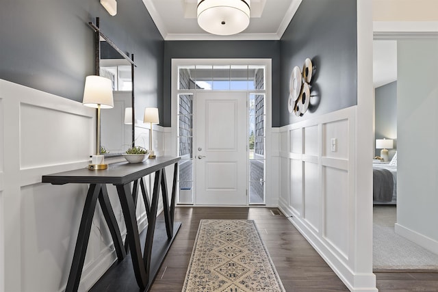3897 Chatham Pl Unit 103, Brighton, MI 48114 - foyer entrance with a barn door, a decorative wall, crown molding, wainscoting, and dark wood-style flooring
