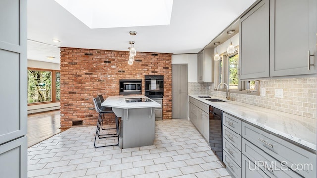 kitchen with a wealth of natural light, black appliances, and gray cabinetry