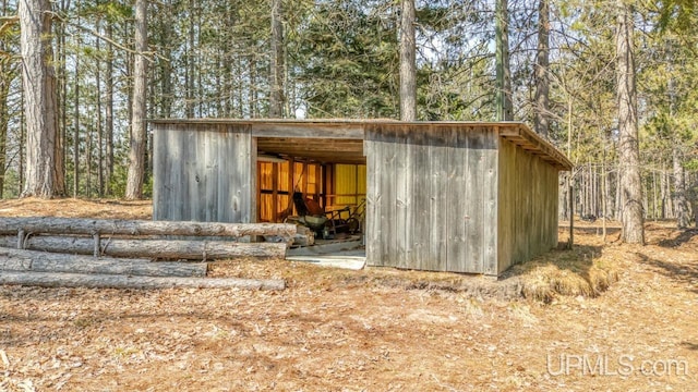 view of pole building featuring a forest view