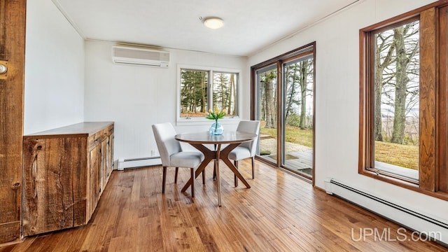 dining space featuring a baseboard radiator, an AC wall unit, crown molding, and wood finished floors