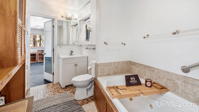 full bathroom featuring toilet, a tub with jets, and vanity