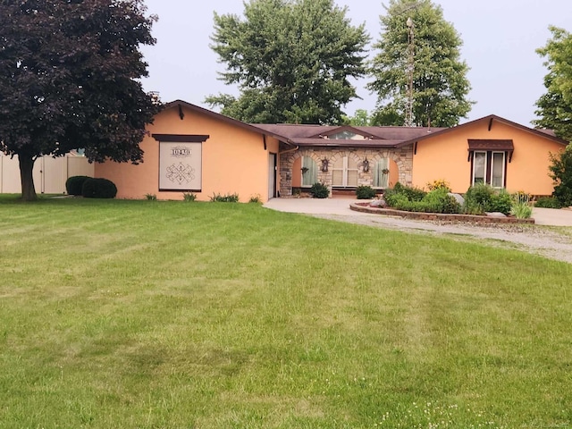 single story home featuring stucco siding, an attached garage, a front yard, and concrete driveway