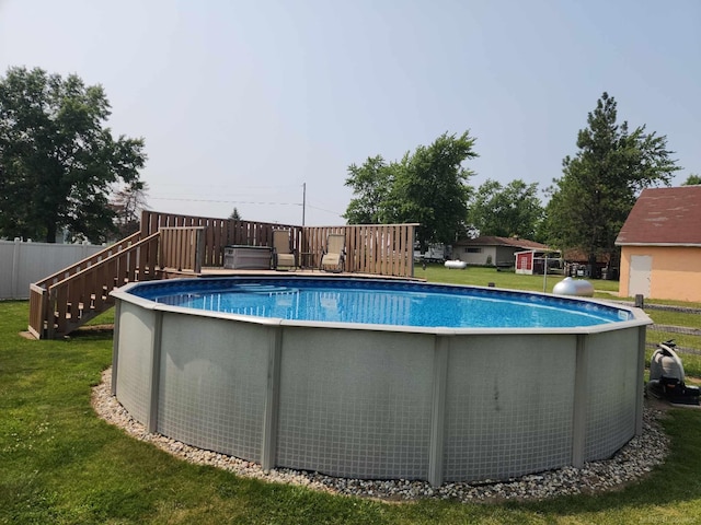 view of pool with a lawn, a deck, and a fenced in pool