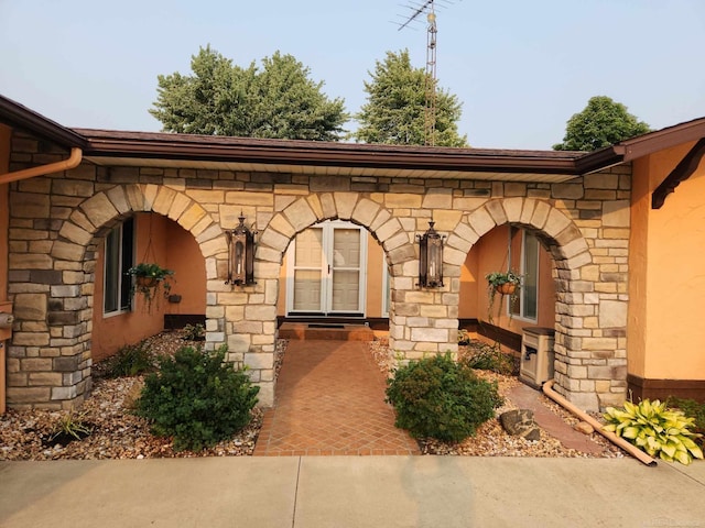 doorway to property with stone siding