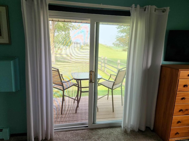 doorway with carpet floors and plenty of natural light