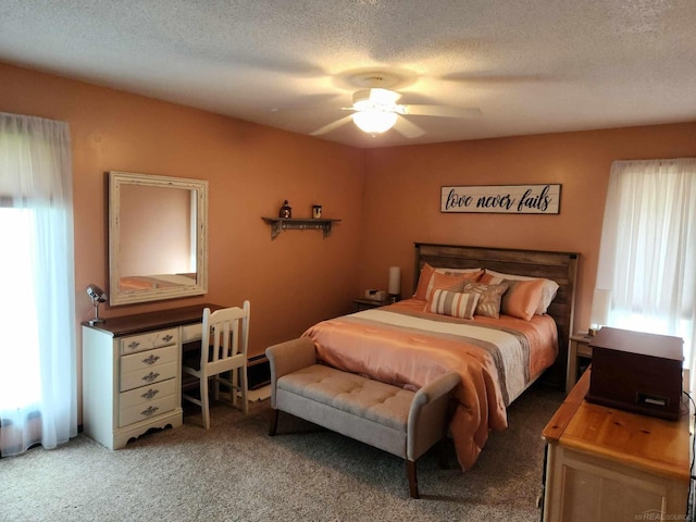 bedroom featuring a textured ceiling, a ceiling fan, and light colored carpet