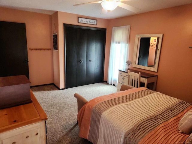 carpeted bedroom with a closet and ceiling fan