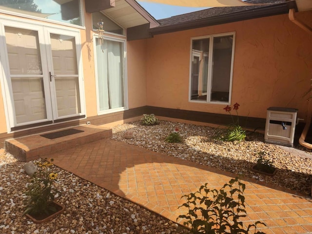 property entrance featuring a patio and stucco siding