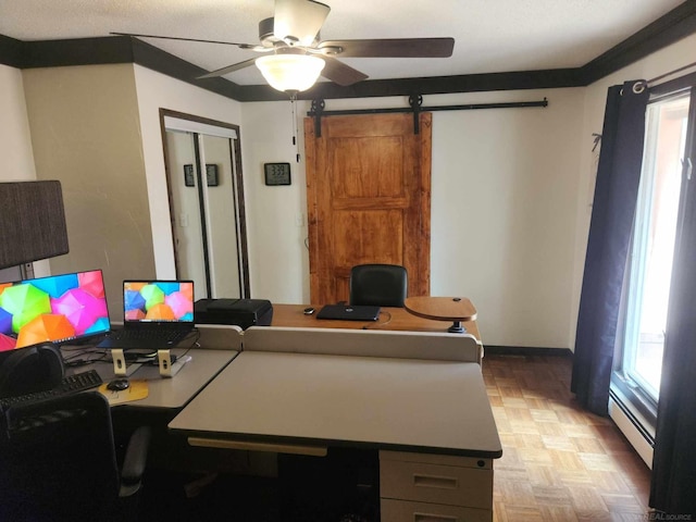 office featuring a baseboard heating unit, ceiling fan, a healthy amount of sunlight, and a barn door