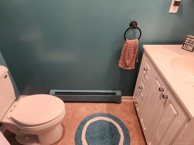 bathroom featuring a baseboard radiator, baseboards, toilet, and vanity