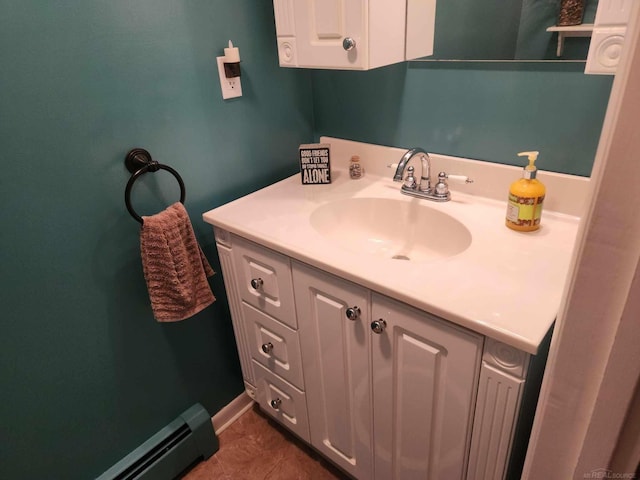 bathroom with a baseboard heating unit, tile patterned floors, and vanity