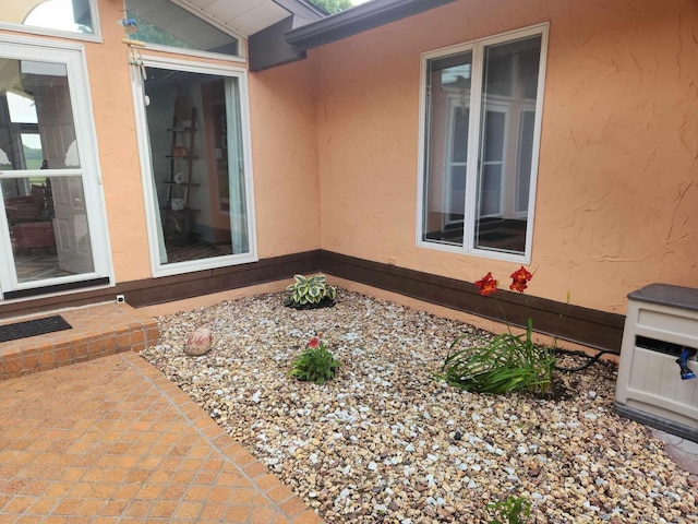 property entrance with stucco siding