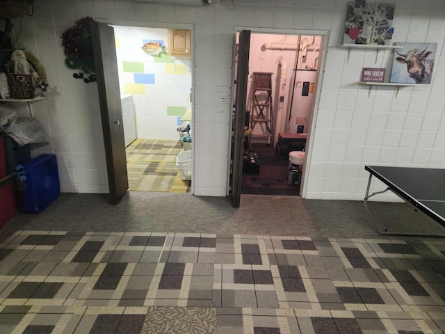 interior space featuring tile walls and carpet floors
