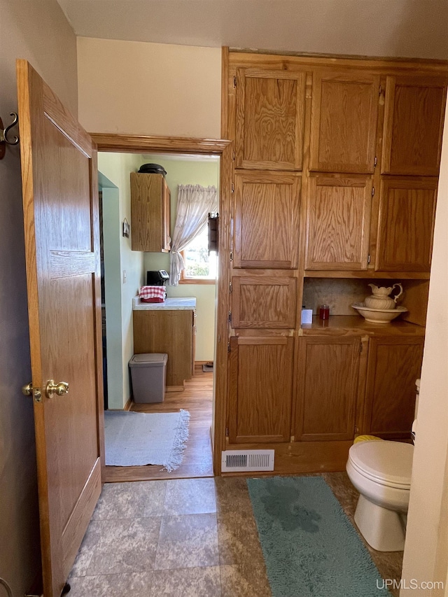 bathroom featuring toilet and visible vents