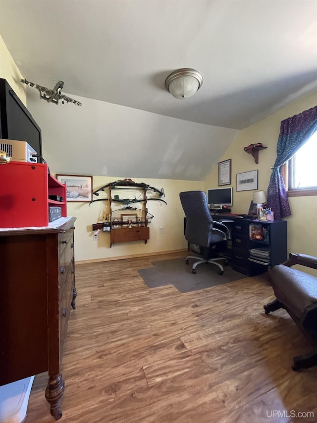 office featuring vaulted ceiling, wood finished floors, and baseboards