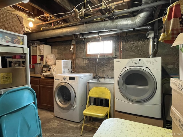washroom with washing machine and clothes dryer and laundry area