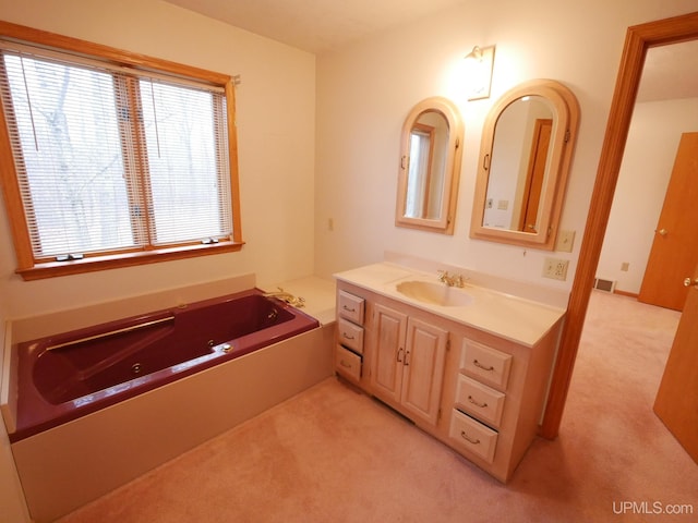 full bathroom with vanity, visible vents, and a jetted tub