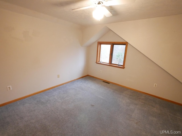 additional living space featuring lofted ceiling, baseboards, carpet floors, and ceiling fan