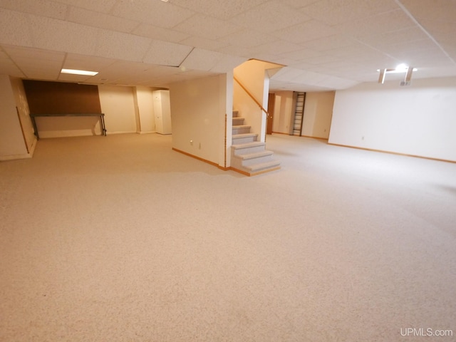 finished below grade area featuring baseboards, carpet floors, and stairs