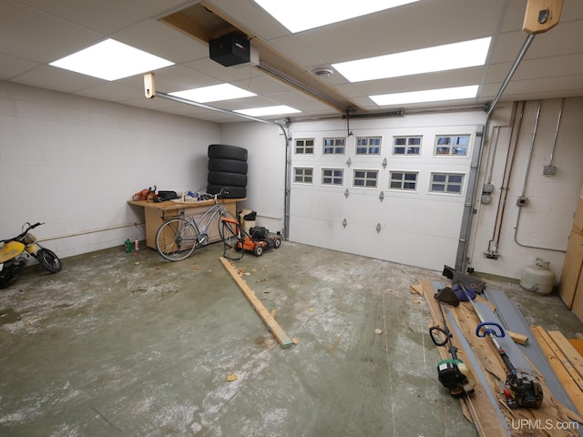 garage with concrete block wall and a garage door opener