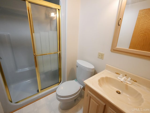full bathroom with toilet, vanity, tile patterned floors, and a stall shower