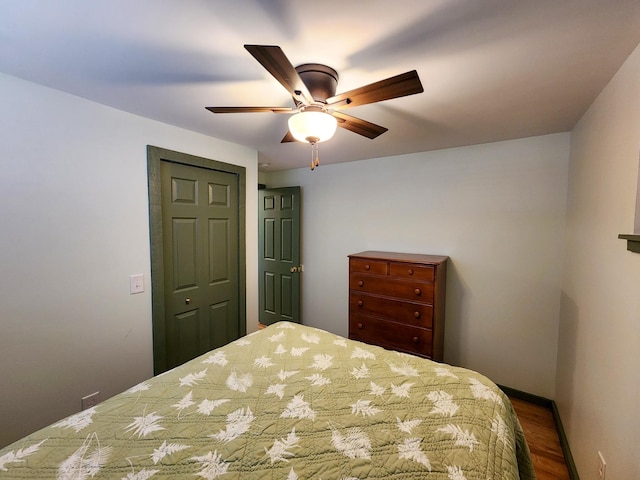 bedroom featuring baseboards, a ceiling fan, and wood finished floors