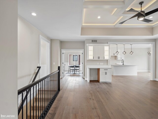 unfurnished living room featuring ceiling fan, wood finished floors, a sink, and recessed lighting
