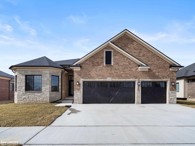 view of front of house featuring brick siding, driveway, stone siding, and a front yard